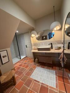 a bathroom with a sink and a large mirror at Maison Romy in Chinon +57 photos