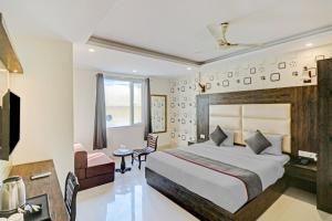 a hotel room with a large bed and a desk at The Nirvana Delhi Airport - FREE Airport Drop in New Delhi +71 photos