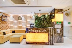 a reception area of a store with a couch and a table at The Nirvana Delhi Airport - FREE Airport Drop in New Delhi