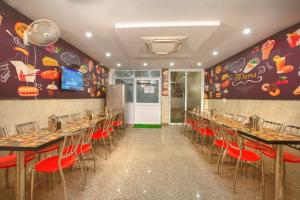 a row of tables and chairs in a restaurant at The Nirvana Delhi Airport - FREE Airport Drop in New Delhi