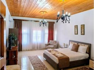 a bedroom with a bed and a chair in it at House in the old town with view in Gjirokastër