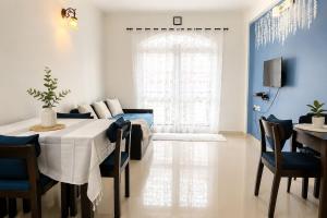 a living room with a dining room table and a couch at 400 m from thE beach 1bhk in Colva