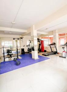 a gym with several treadmills and other fitness equipment at 400 m from thE beach 1bhk in Colva