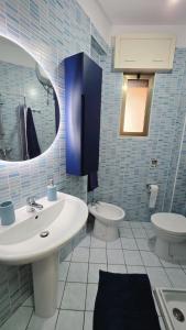a blue tiled bathroom with a sink and a toilet at Viben House in Gallipoli +16 photos