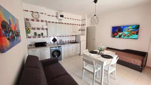 a kitchen and living room with a couch and a table at Viben House in Gallipoli