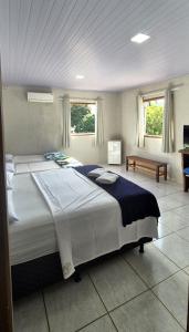 a large bedroom with a large bed in it at Pousada Chafariz in Pirenópolis