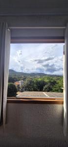 a window with a view of a city at Pousada Chafariz in Pirenópolis