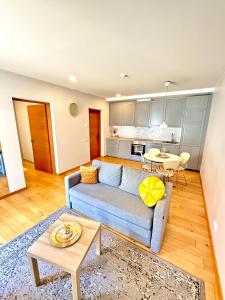 a living room with a blue couch and a table at Matas old town apartment in Kaunas
