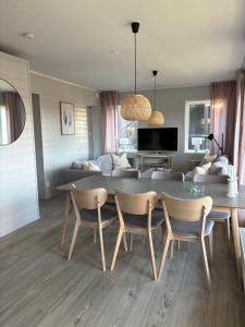 a living room with a table and chairs and a couch at Panorama 3 Kungsberget in Järbo
