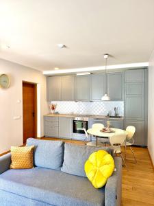 a living room with a blue couch and a table at Matas old town apartment in Kaunas