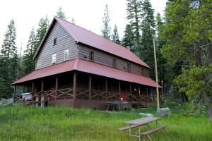 a large wooden barn with a red roof at Drakesbad Guest Ranch in Chester