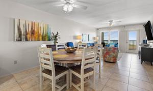 a dining room and living room with a table and chairs at Edgewater Condo Unit #304 in South Padre Island