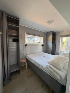 a bedroom with a bed and a window at Panorama 3 Kungsberget in Järbo