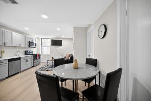 a kitchen and dining room with a table and chairs at Elegant 2BR apartment with updated kitchen in Reading