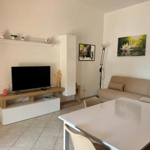 a living room with a flat screen tv on a table at Luciana House in Olbia
