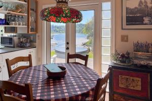 a kitchen with a table with a laptop on it at Eagle Harbor House World Cup Availability in Winslow