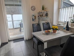 a kitchen with a table with a bowl of fruit on it at Dümmernest in Hüde