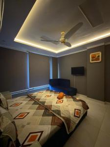 a bedroom with a bed with a ceiling at Maison Eleve Residency in Lahore