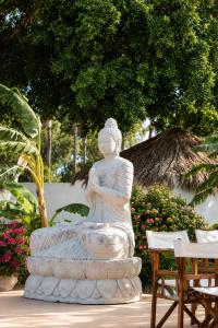 a statue of a woman sitting in a fountain at BLACK AMBER BOUTIQUE HOTEL in Lampi
