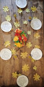 a wooden table with plates and flowers on it at Im Laret, Lavin in Zernez