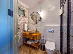 a bathroom with a toilet and a mirror at Cundalis1893 in Ayvalık +15 photos