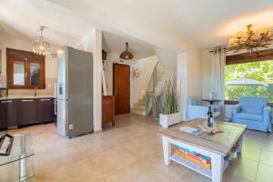 a living room with a table and a kitchen at Villa Malvina in Neos Marmaras