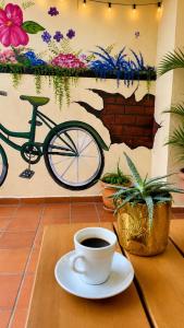 a cup of coffee sitting on a table next to a bike at Casa hostal la herradura in San Vicente de Chucurí +7 photos