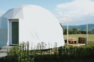 a white dome house with a view of a field at Glamping-Steiermark in Pöllauberg