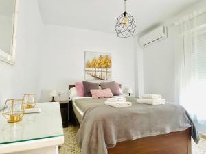 a bedroom with a bed with two towels on it at City center with amazing sea view in Torre del Mar +12 photos