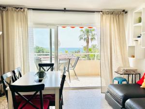 a living room with a table and a view of the ocean at City center with amazing sea view in Torre del Mar