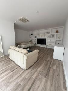 a living room with a couch and a television at Sunrise House 26 in Ponta Delgada