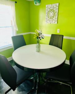 a white table with chairs and a vase of flowers at The Get Away Haven in Stockbridge +19 photos