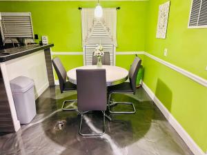 a dining room with green walls and a table and chairs at The Get Away Haven in Stockbridge