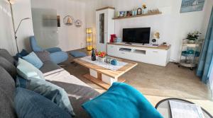 a living room with a couch and a tv at Dümmernest in Hüde +19 photos