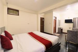 a hotel room with a bed and a chair at Hotel Pun Inn Kathmandu in Kathmandu +19 photos