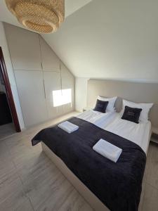 a bedroom with a large bed with two pillows at MB House Sarbinowo in Sarbinowo