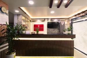 a lobby of a hotel with a reception desk with plants at Hotel Pun Inn Kathmandu in Kathmandu