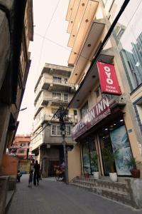 a building on a street with people walking in front of it at Hotel Pun Inn Kathmandu in Kathmandu
