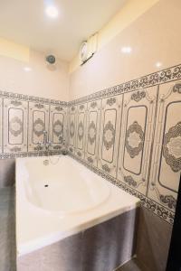 a bathroom with a bath tub in a room at Hotel Pun Inn Kathmandu in Kathmandu