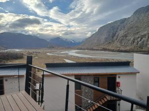 a balcony with a view of a river and mountains at Panorama Aparts Chalten in El Chalten