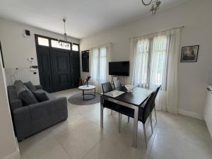 a living room with a couch and a table at The Mulberry House Heritage by the Sea in Alexandroupoli
