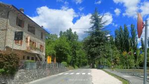 an empty street with a building and a tree at Da Carlo in Pietralunga