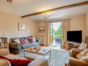 a living room with a couch and a tv at 3 Bed in Langport oc-76372 in Drayton