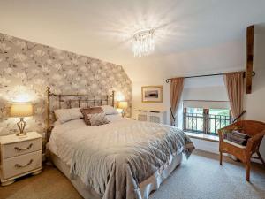 a bedroom with a large bed and a window at 3 Bed in Langport oc-76372 in Drayton