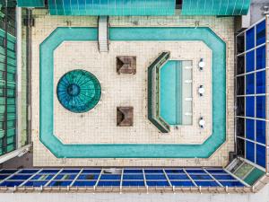 a swimming pool in the middle of a building at Grand Tuscany Hotel in Houston