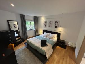 a bedroom with a bed with a laptop on it at Bela vista AL in Paredes de Coura