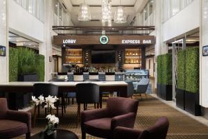a restaurant with a large table and chairs and a bar at Holiday Inn Toronto Downtown Centre by IHG in Toronto