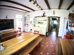 a dining room with wooden tables and benches at Siedlisko Szwałk in Szwalk
