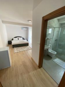 a bedroom with a bed and a glass door at Venecia gold in Struga +26 photos