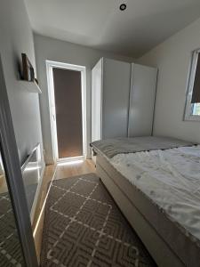 a bedroom with a bed and an open door at Hammar Hus in Kristianstad